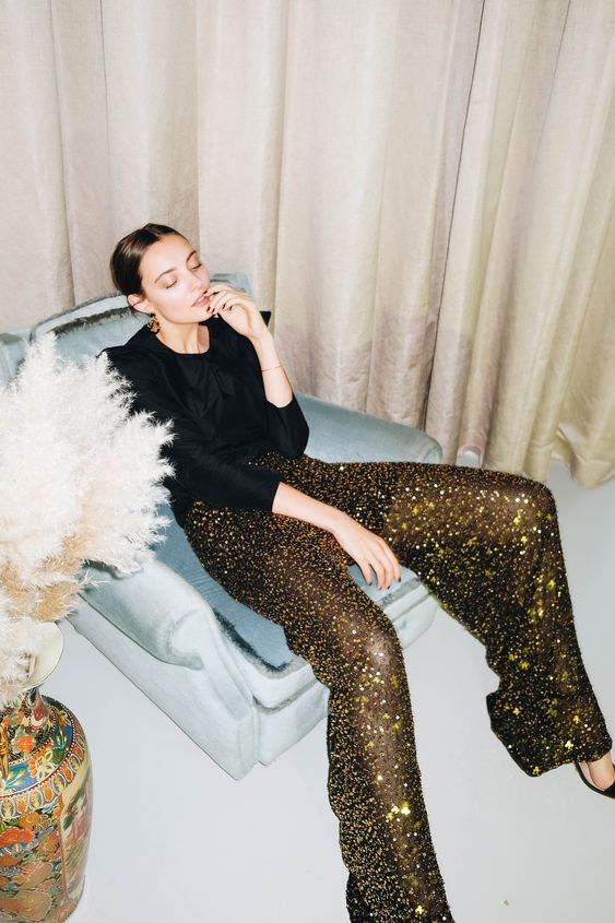 black and gold sequin semi sheer pants, a black top and a black cropped blazer are a gorgeous NYE combo