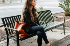 a casual look with navy skinnies, a striped top, a black leather jacket, ocher ankle booties and a cognac tote