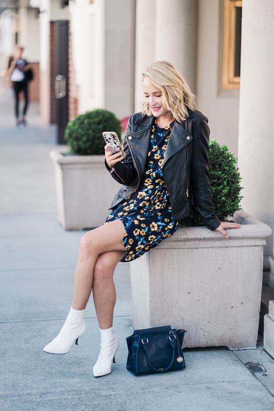 a dark floral mini dress, a black oversized leather jacket, white booties, a black bag for spring or fall