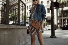a printed over the knee dress, a cropped dehim jacket, white ankle booties and a crossbody bag