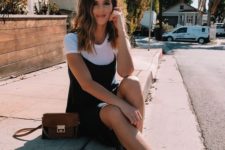 a white tee, a black slip knee dress, white booties, a brown crossbody bag for a spring look