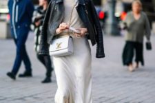 a white top, a layered flowy skirt, a black leather jacket, black lacquer boots and a white bag