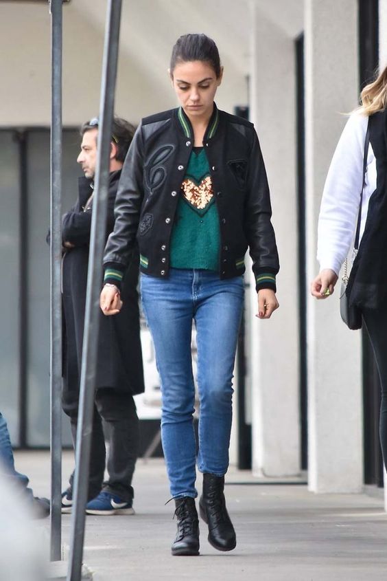 an embellished green sweatshirt, blue skinnies, a black bomber jacket and black combat boots