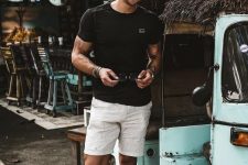 a black tee, white linen shorts and black flipflops for a cool holiday look with no effort