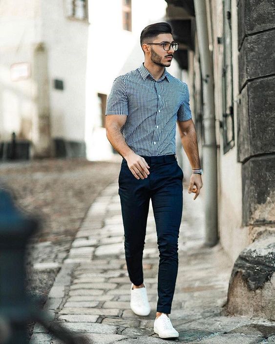 a blue plaid shirt with short sleeves, navy chinoes, white sneakers for a summer work look