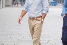 a blue striped shirt, tan chinos and white sneakers to create a comfortable casual look for work