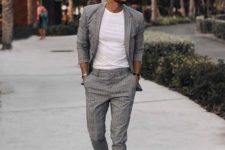 a grey checked suit, a white tee and white sneakers for a casual busuiness summer look