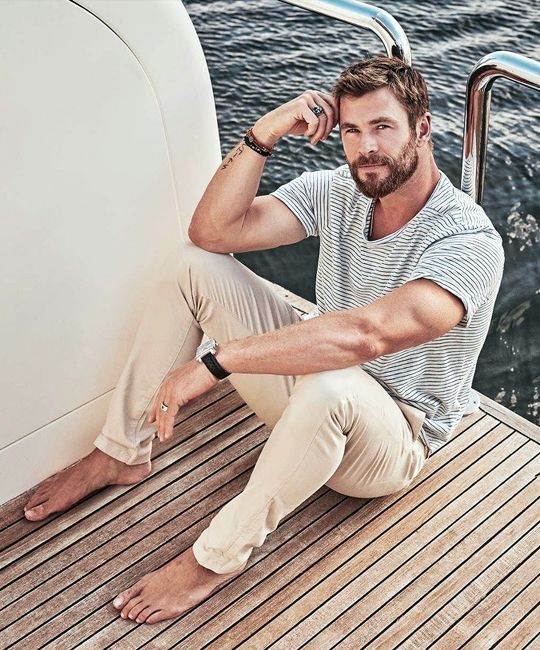 a striped blue tee, tan pants are a perfect combo for your relaxed seaside holiday