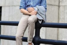 a trendy men outfit with bright blue loafers, a checked blue shirt, tan pants and a grey blazer