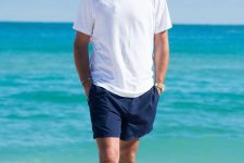 a white oversized tee, navy shorts are all you need to feel comfortable by the seaside