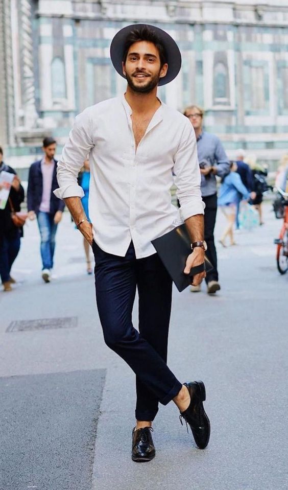 a white shirt, navy pants, black shoes and a black hat for a creative summer work look