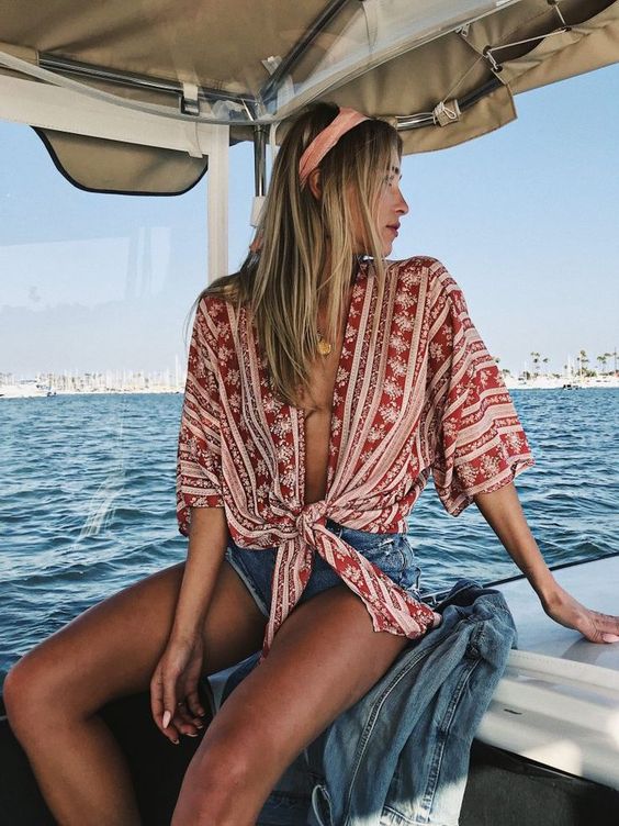 a red and blush printed tied up shirt, denim shorts and a headband for a free-spirited look