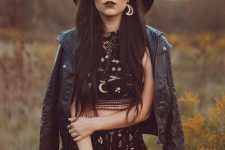 a statement summer to fall boho look with a black suit with a crop top and shorts, a black leather jacket and a hat