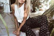 a white tank top tied, black and white printed pants for a monochromatic boho outfit