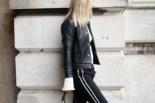 a casual outfit with a white top, black side stripe pants, white sneakers, a black bag
