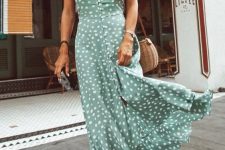 a green and white polka dot maxi sundress with buttons, woven slippers and a wicker bag for a hot day