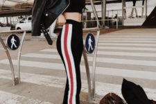 a sexy outfit with a black crop top, black side stripe pants, white sneakers, a black leather jacket