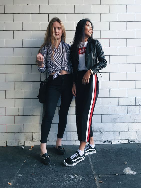 a stylish outfit with a white printed tee, black side stripe pants, black sneakers and white socks and a black leather jacket