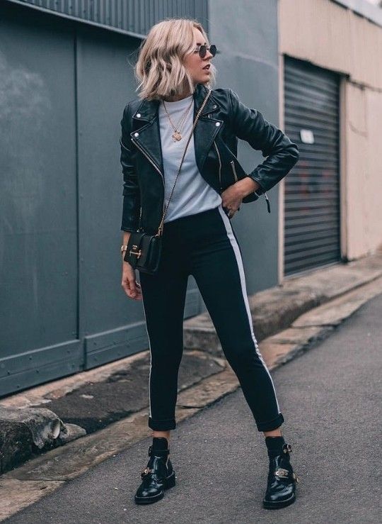 a stylish outfit with a white tee, black side stripe pants, a black leather jacket and black boots