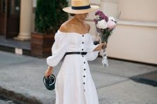 a white A-line maxi button up dress with long sleeves, two tone slingbacks and a hat for vintage look