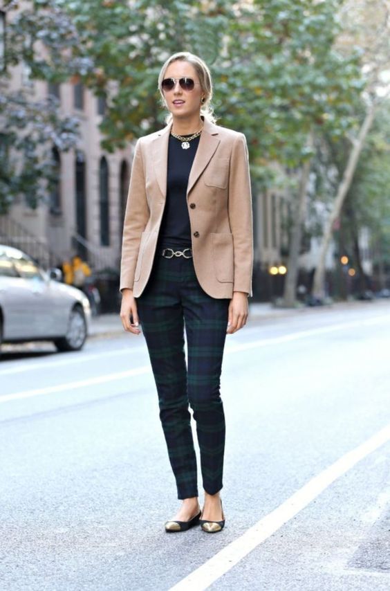 a black top, checked pants, a camel blazer, black and gold flats plus a statement necklace