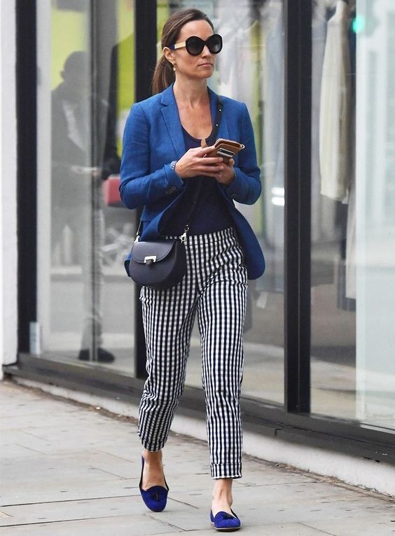 a bold outfit with a navy top, a bright blue blazer, cobalt blue flats and checked pants plus a black bag