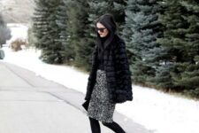 a black turtleneck, a silver sequin skirt, black tights and shoes and a faux fur coat
