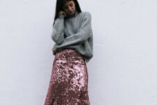a casual holiday look with an oversized grey sweater, a pink sequin midi skirt, white sneakers and statement earrings