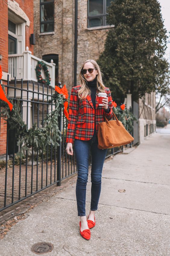 a classic Christmas look with a black turtleneck, navy skinnies, red loafers, a red plaid blazer and a rust bag