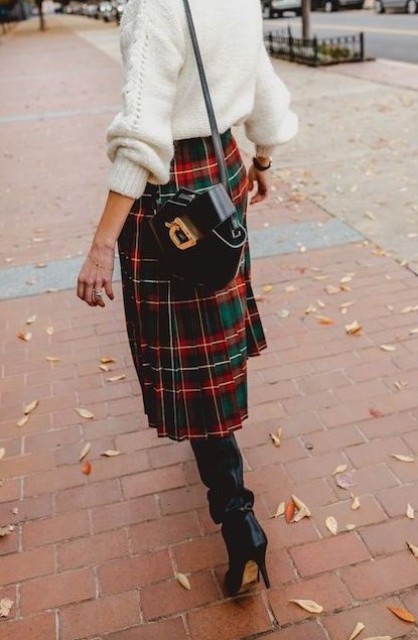 a cozy white sweater, a plaid pleated midi skirt, black boots and a black bag for a cozy look