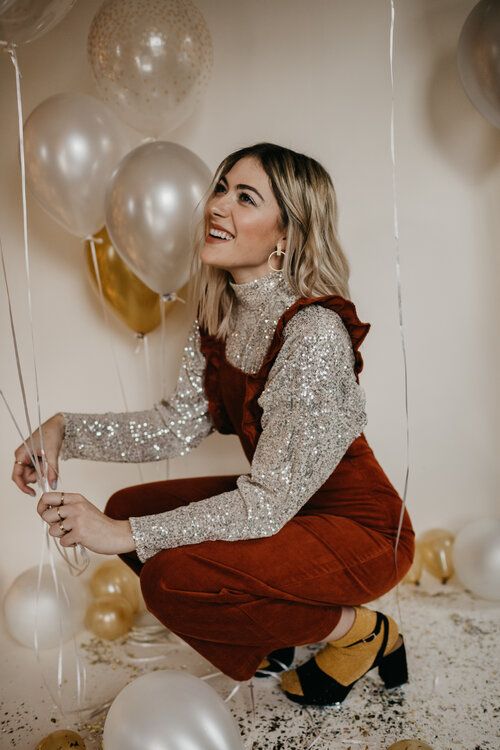 a creative party look with a silver sequin turtleneck, a rust-colored corduroy overall, yellow socks and black shoes