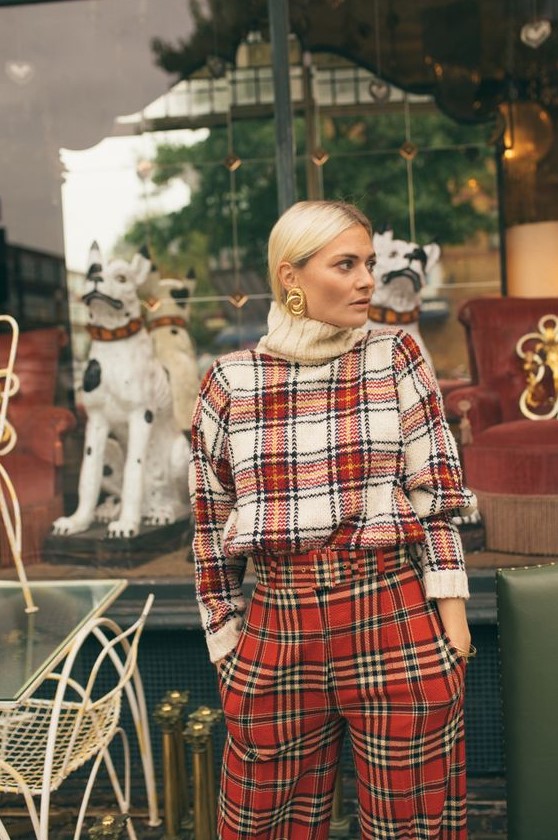 a super bold and creative double plaid look with an oversized sweater and pants that mismatch but look cool together