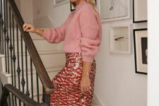 an elegant Christmas outfit with a pink sweater, a pink printed sequin midi, black slingbacks and pearl earrings