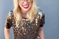 a short sleeve gold sequin top and red plaid pants plus a gold glitter glasses frame are a fun party look