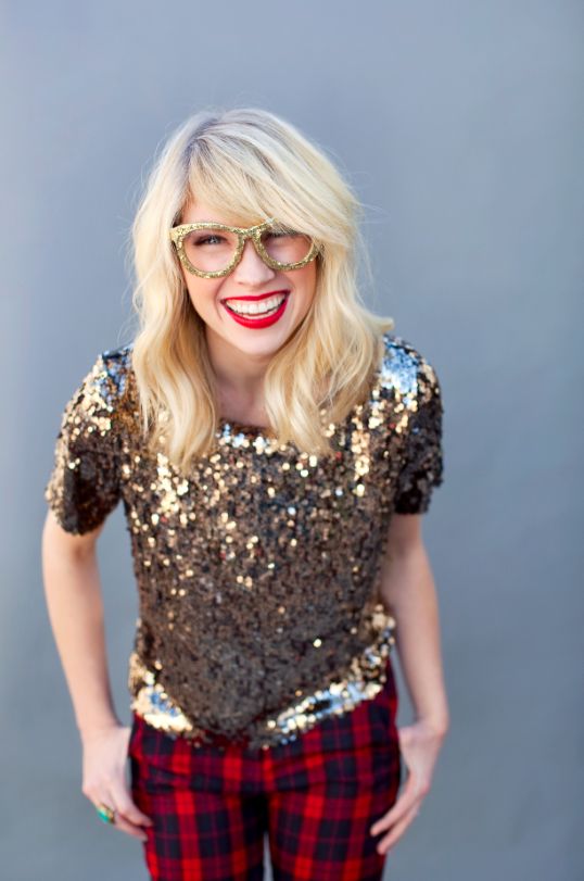 a short sleeve gold sequin top and red plaid pants plus a gold glitter glasses frame are a fun party look