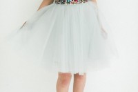 a colorful sequin top with short sleeves, a white tutu skirt and red shoes compose a fun and cool Christmas party look