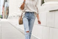 a striped shirt, blue ripped skinnies, nude mules and a wicker round bag for s spring to summer look