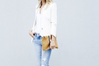 a spring outfit with blue ripped jeans, a white top and blazer, white kitten heel shoes and a brown clutch