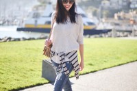 an oversized neutral top, a striped turtleneck, blue skinnies, nude shoes and a brown bag