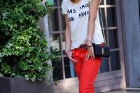a colorful spring look with a printed tee, red pants, leopard print flats and a black crossbody