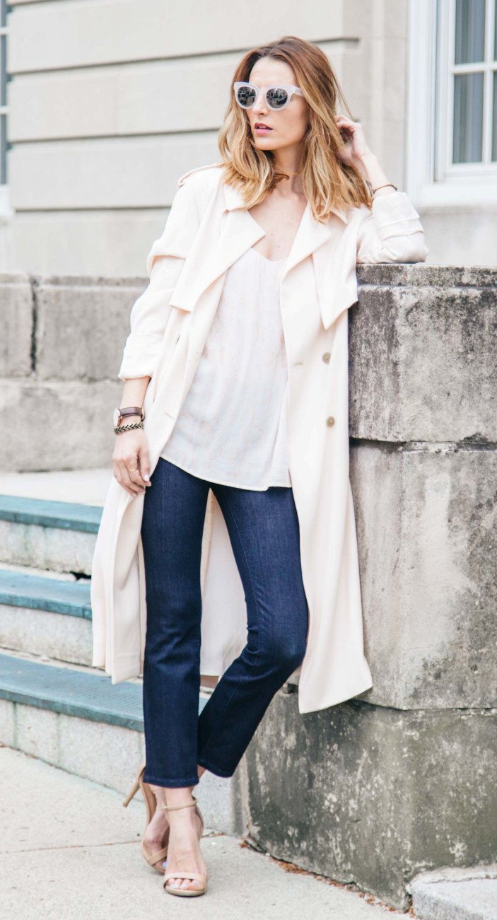 a spring outfit with navy straight jeans, a white top, nude shoes and white trench