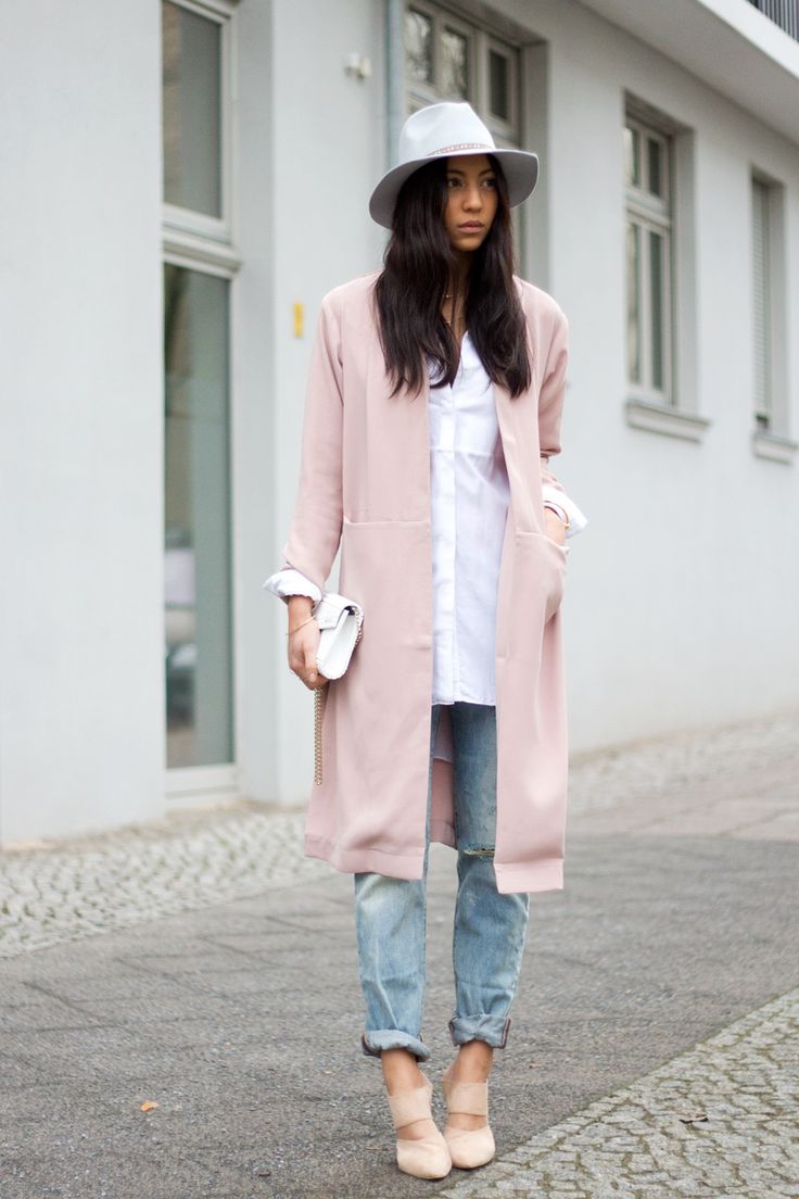 an oversized white shirt, blue ripped jeans, a long blush blazer, a white hat and nude shoes