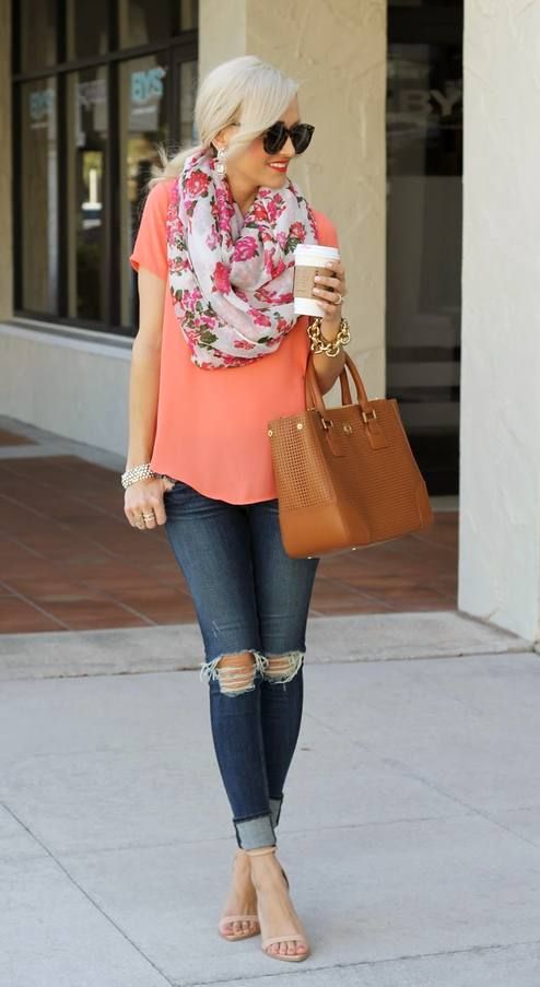 a bright spring outfit with a coral top, a floral scarf, navy ripped jeans, nude shoes and a brown bag
