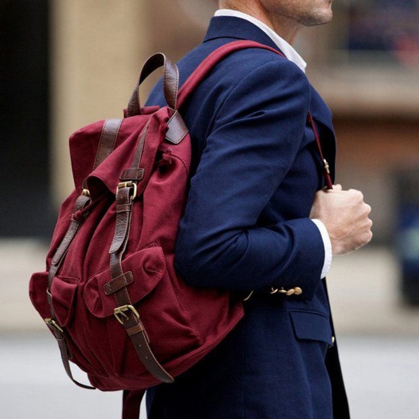 a burgundy fabric backpack is a nice colorful ottouch to most of your outfits