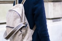 a chic modern neutral backpack with brown straps is a stylish and very contemproary accessory