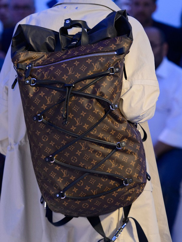 a trendy LV backpack with its traditional print, lacing up and a black top is super stylish