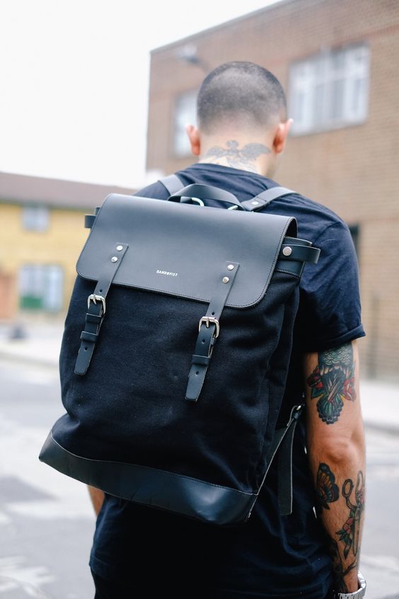 a stylish modern black backpack of leather and suede looks very masculine and makes a brutal statement