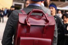 a super bold burgundy leather backpack with a top handles for carrying it as a bed