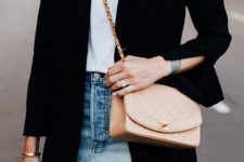 a white tee, a blue ripped mini skirt, a black long blazer and a neutral bag compose a sexy look
