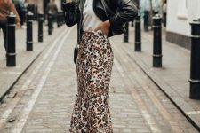 a white tee, an animal print midi skirt, a black leather jacket, white sneakers and a crossbody